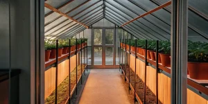 Serre moderne avec rangées de pots de cannabis cultivés en intérieur sous lumière contrôlée